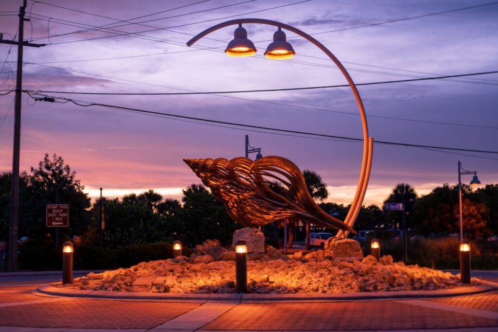 conch shell statue at the Beach Road roundabout on Manasota Key shortly after sunset