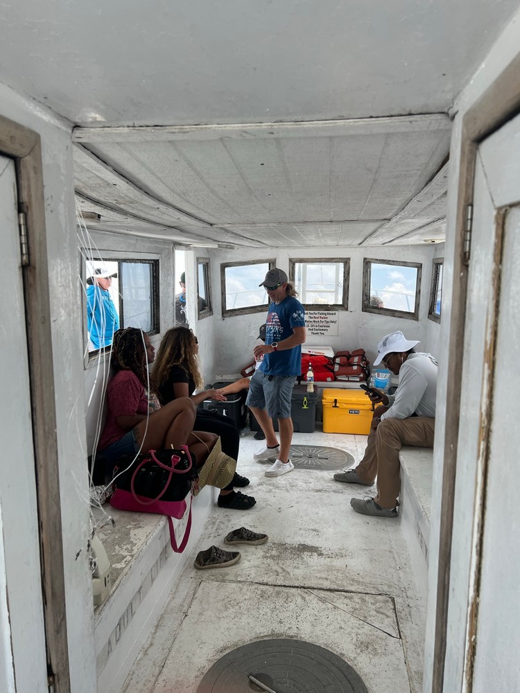 people sitting inside the cabin of a charter boat